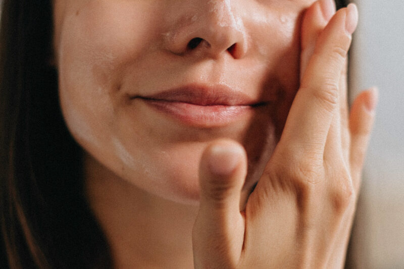 Woman applying face serum.