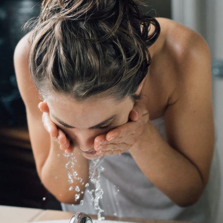 Image of woman washing face