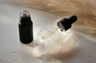 Bottle of facial serum and ice.