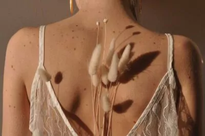 Woman with dry plants on her back