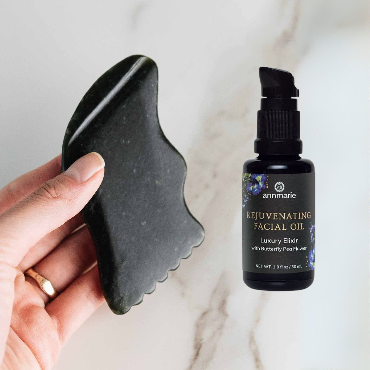Gua sha is on the left half of the photo, the right half of the photo is a picture of the Rejuvenating Facial Oil bottle.