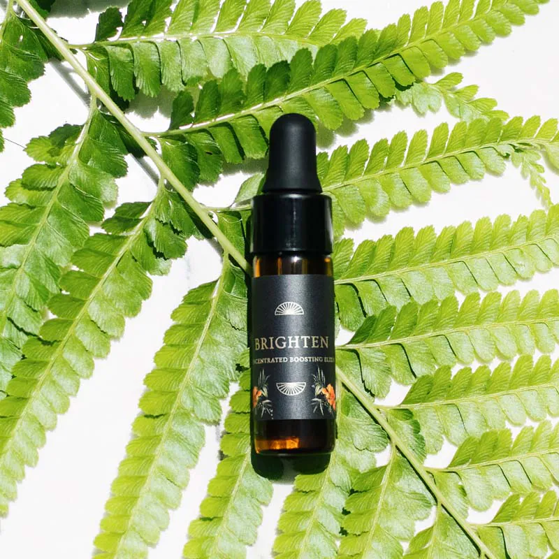 Brighten Boosting Elixir on a fern leaf background
